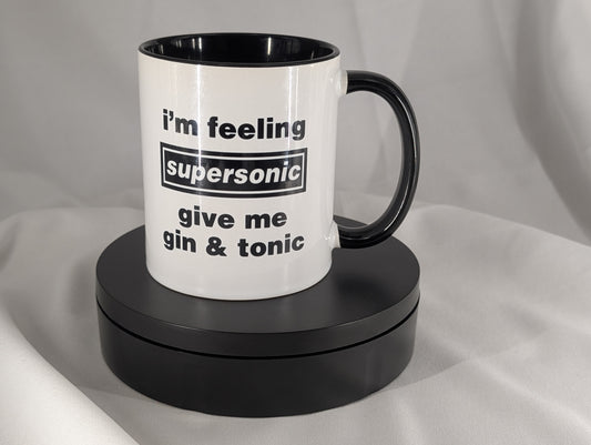 White mug with black interior and handle, featuring text on a gray background