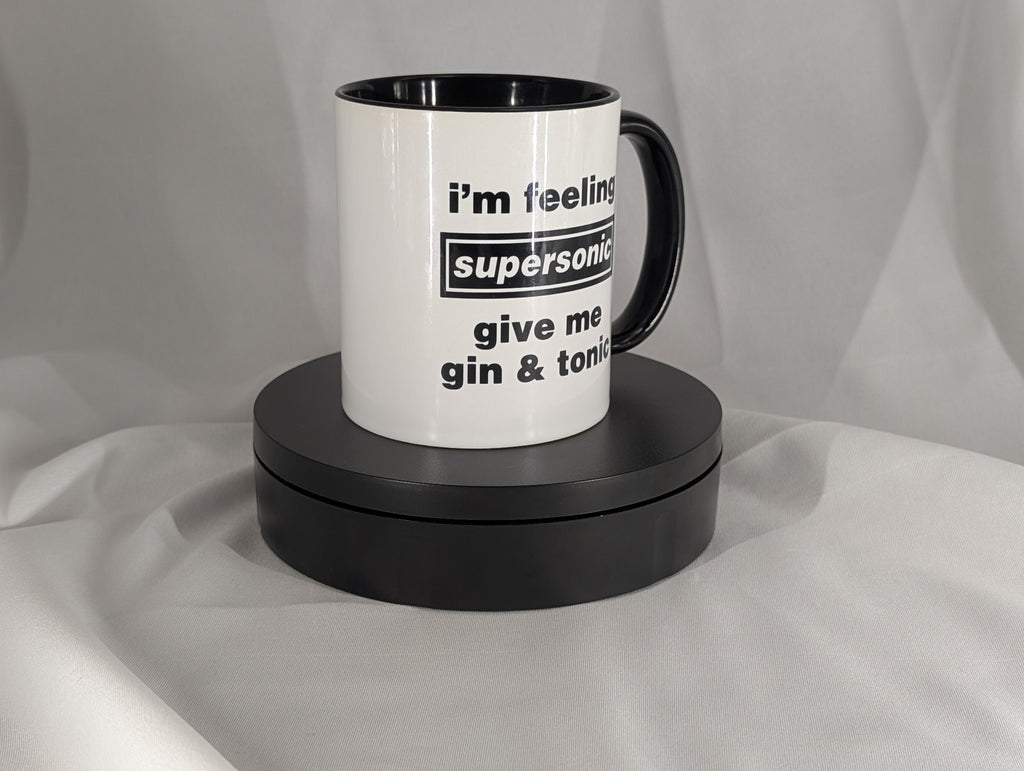 White mug with black interior and handle, featuring text on a gray background