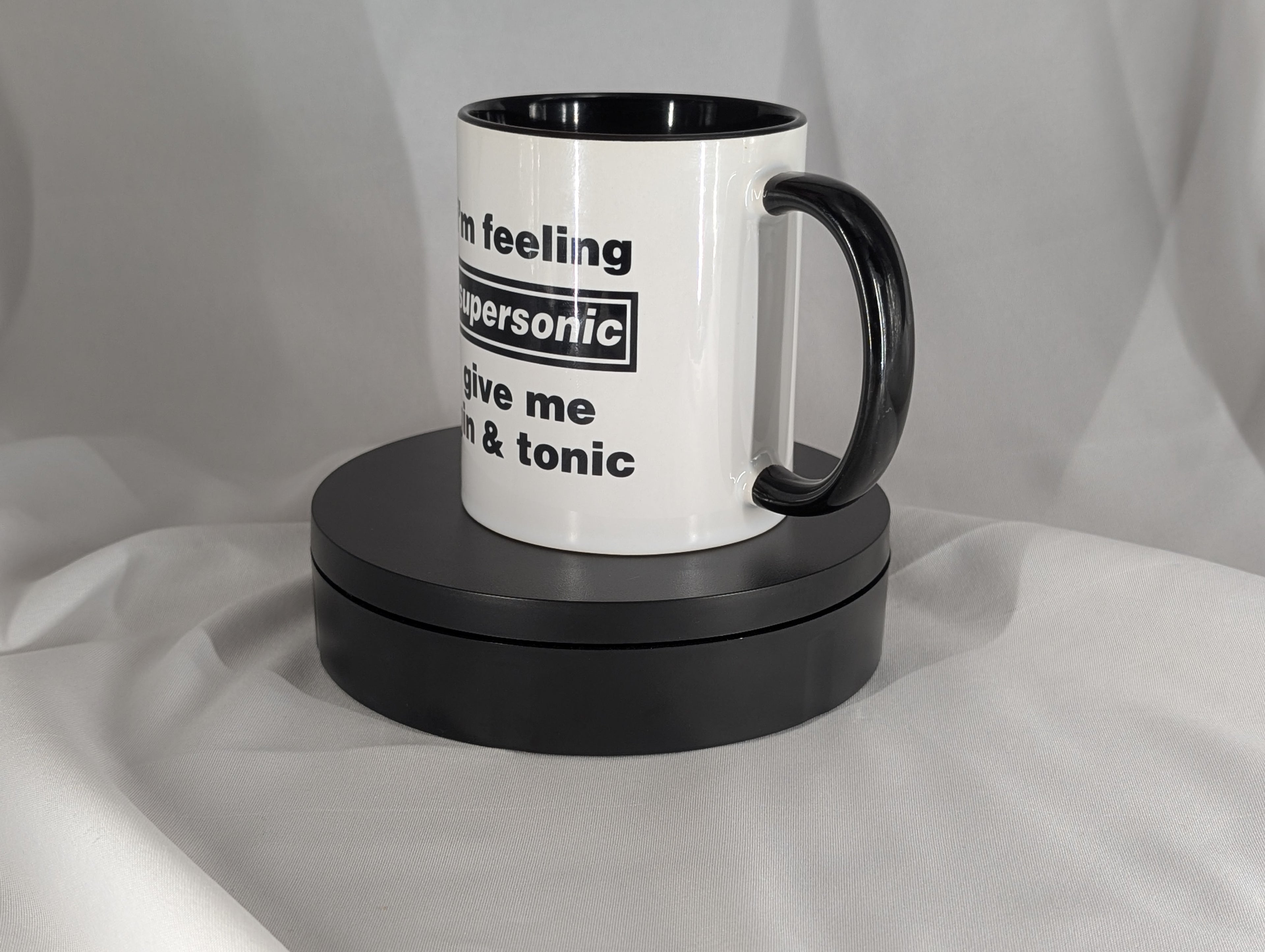 White mug with black handle and text on a white background