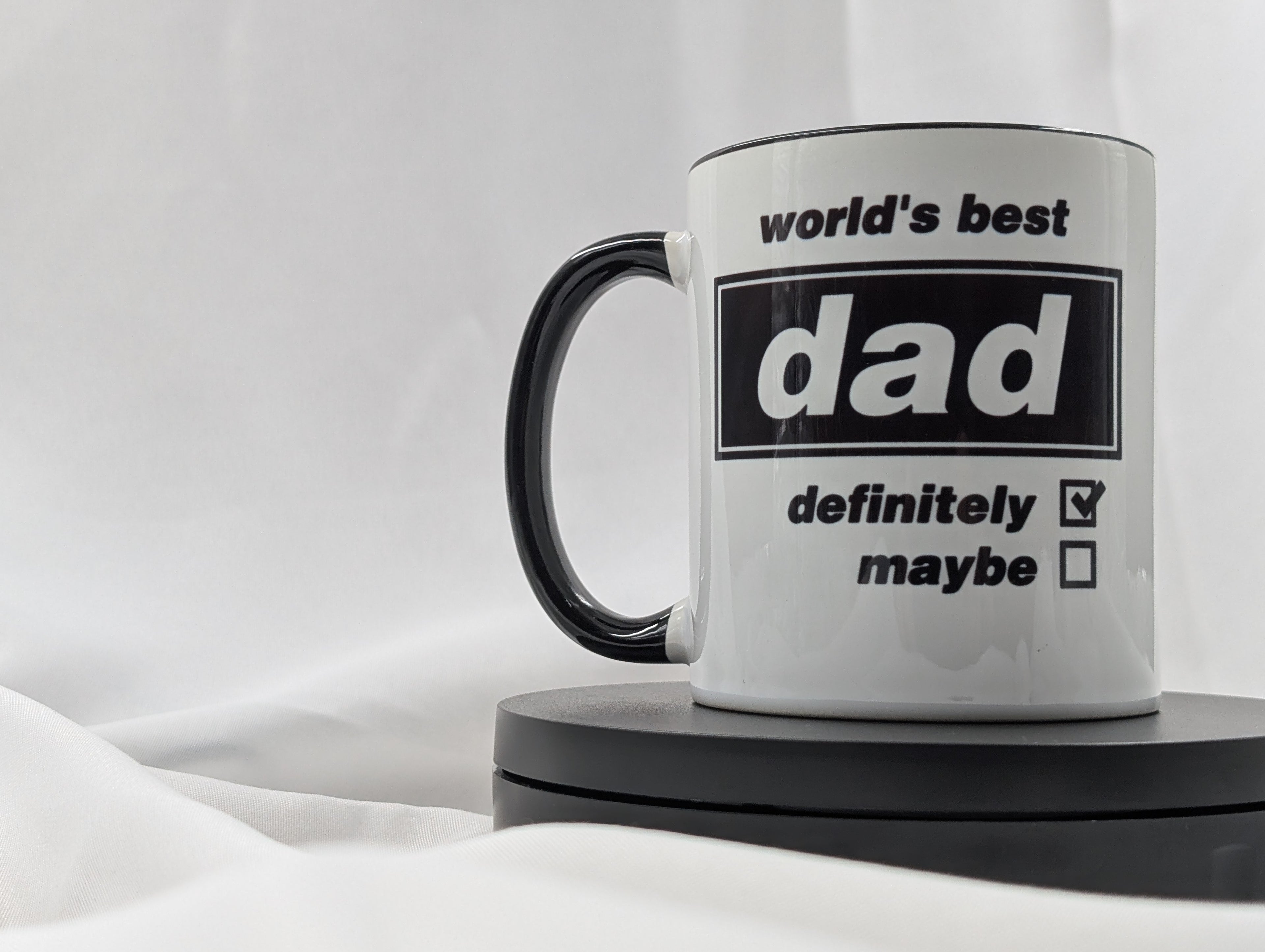 Mug with 'world's best dad definitely maybe' text on a white background
