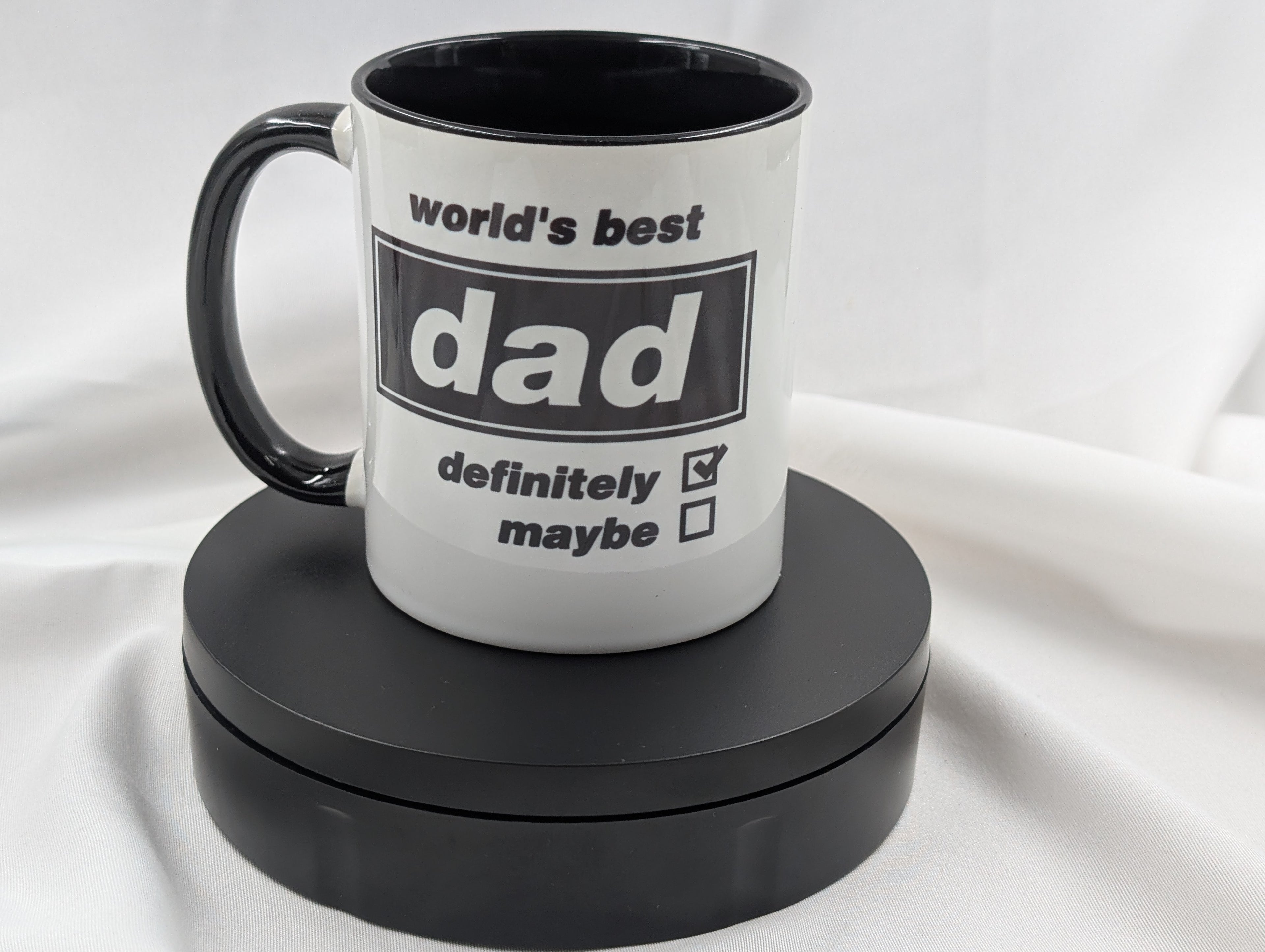 Mug with 'world's best dad definitely maybe' text on a white background